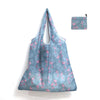 A light blue reusable shopping tote featuring a pink flamingo print, with an attached matching carry pouch.
