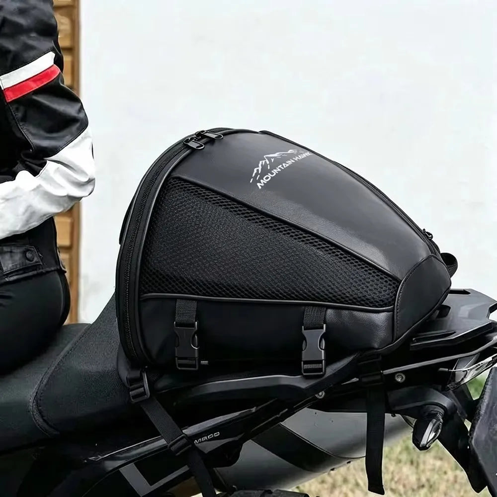 Black motorcycle tail bag mounted on a bike, designed for waterproof rear seat storage.