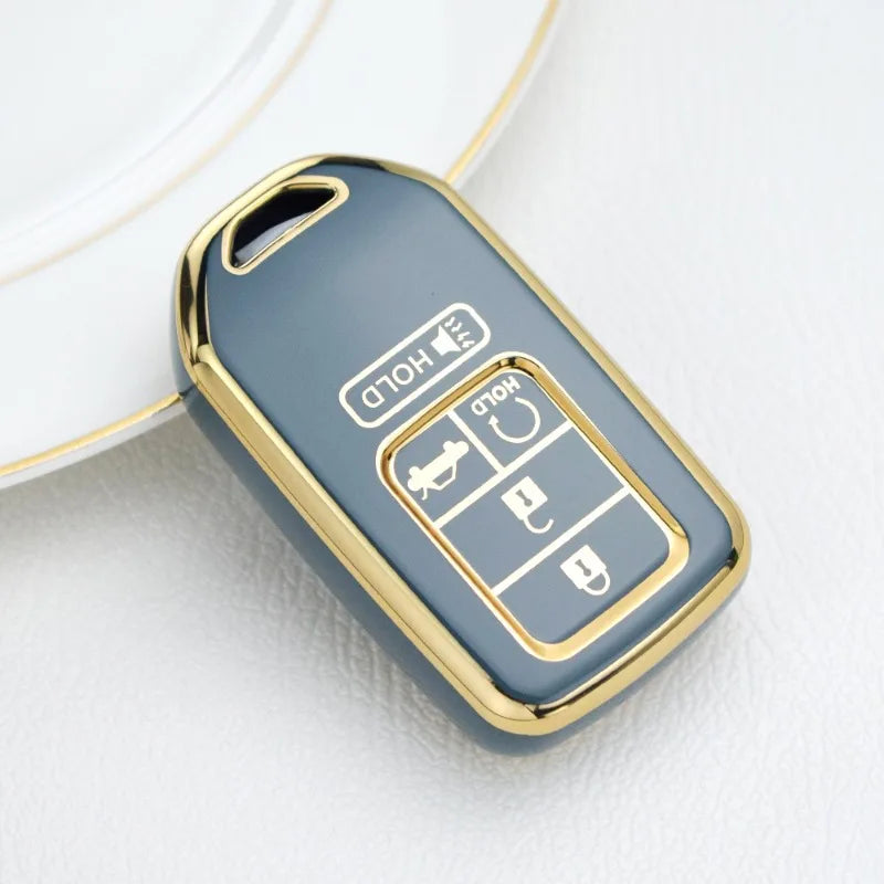 A small, oval, light blue TPU protective key case with gold accents resting on a white surface.