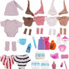 A collection of pink and beige clothing items for dolls including a hat, jumpsuit, socks, and various accessories.