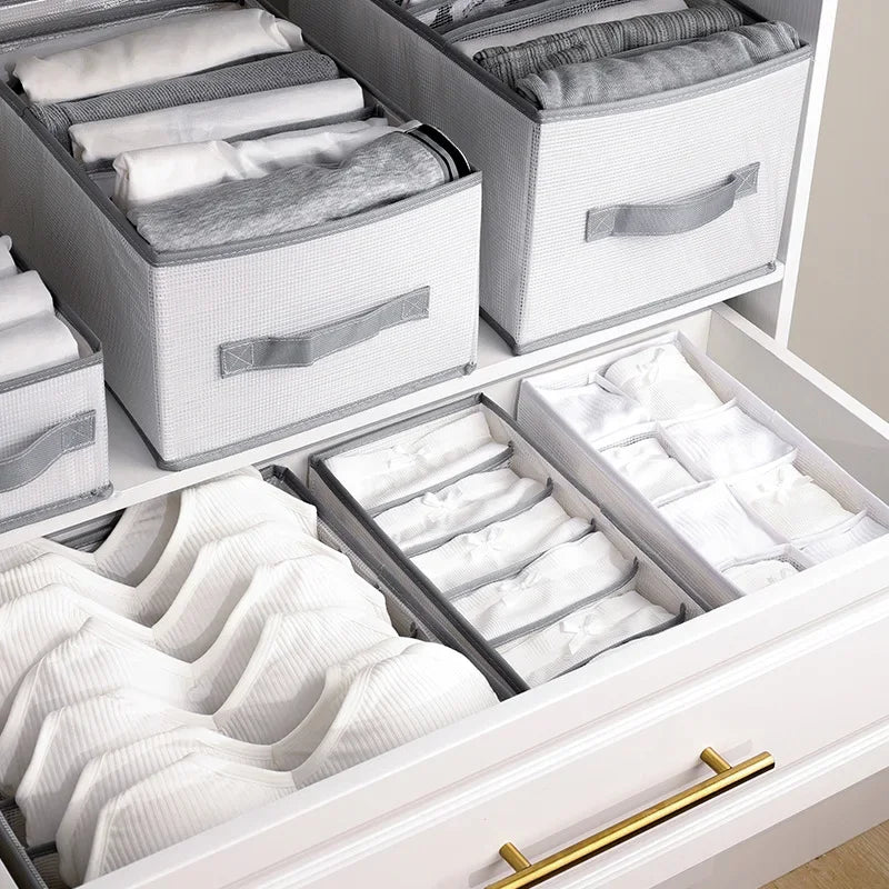 A white foldable closet organizer box with multiple compartments for storing folded underwear, socks, and accessories.