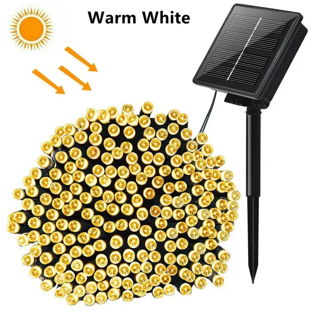 A cluster of warm white solar powered outdoor string lights with numerous LED bulbs.
