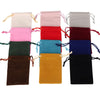 A collection of velvet drawstring jewelry pouches in various colors including pink, red, blue, green, and black.