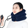 A woman is using a dark blue inflatable cervical traction neck stretcher for pain relief and relaxation.