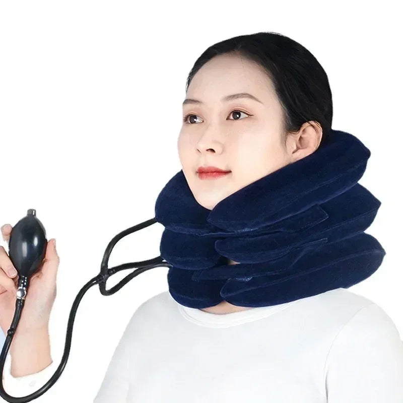 A woman is using a dark blue inflatable cervical traction neck stretcher for pain relief and relaxation.