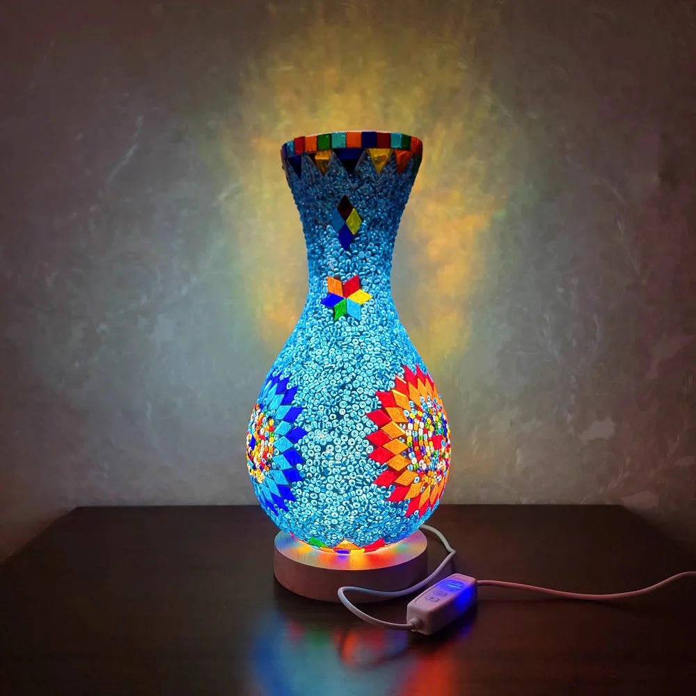 A handcrafted Turkish mosaic table lamp glowing with warm LED light on a dark surface.