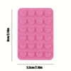 A pink silicone suction phone mount with multiple circular suction cups.