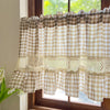 Beige gingham cafe curtain with crochet lace trim hanging in a window.