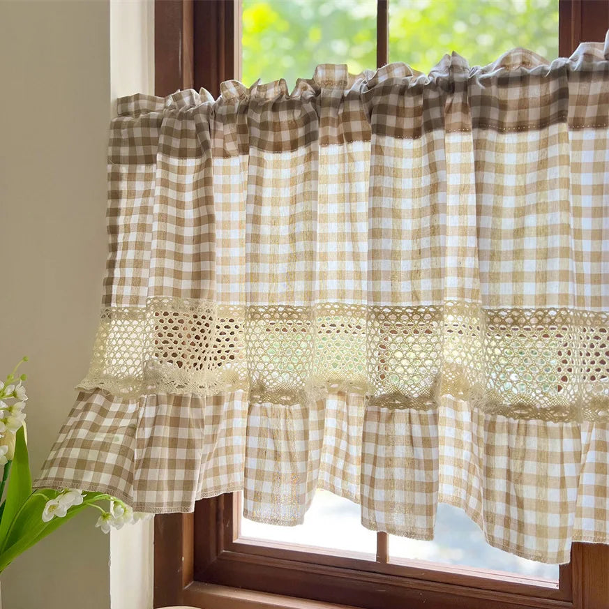 Beige gingham cafe curtain with crochet lace trim hanging in a window.