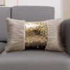 A decorative pillow featuring a silver and gold sequin fabric surrounded by fluffy gray fur trim.