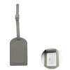 A rectangular gray PU leather luggage tag with a metal clip attached.