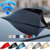 A black shark fin car antenna with various color options displayed on a car surface.