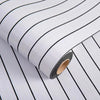 Roll of white and black striped 3D grille pattern peel-and-stick wallpaper