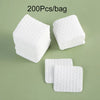 White lint-free cotton rounds packaged in a bag, showing individual square pads.