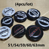Four black and silver wheel center hub caps for Nissan models in various sizes 51/54/59/60/63mm