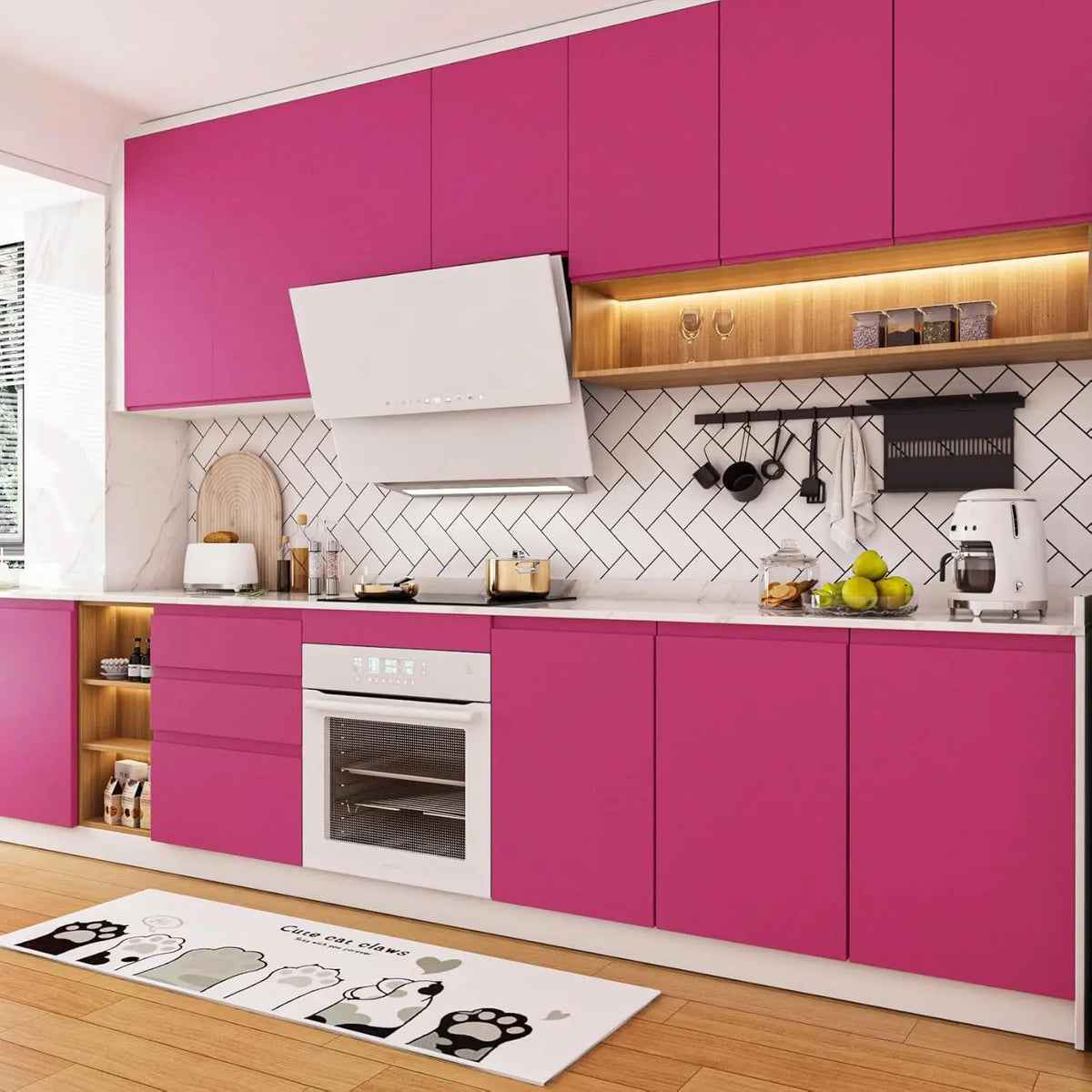 A modern kitchen featuring bright pink cabinets, white countertops, and a peel-and-stick wallpaper roll on the floor.
