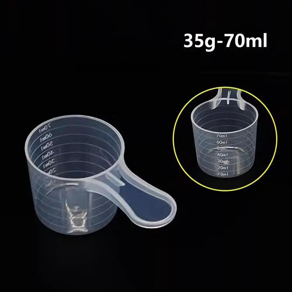 Clear plastic measuring cup with graduated markings for liquid volume measurement