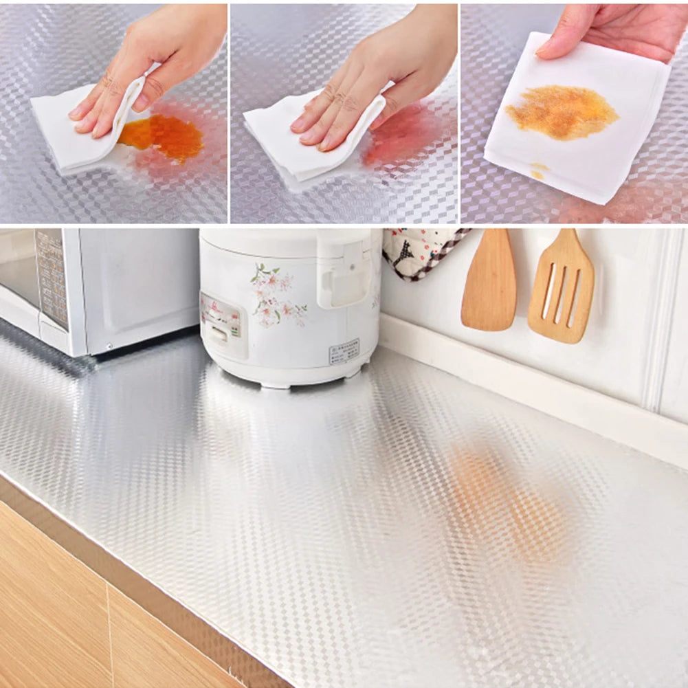 Demonstration of an aluminum foil kitchen backsplash sticker protecting a wall surface from spills and stains.