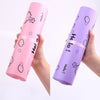 A hand holds a purple self-sealing mailing bag featuring a white Hello bear design.