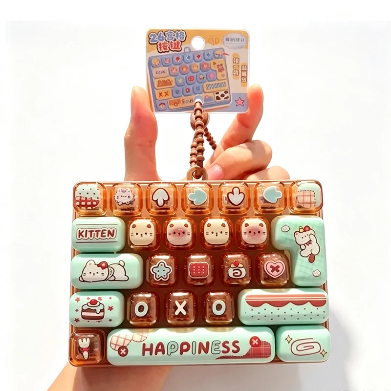 A colorful plastic fidget keychain featuring various cartoon-themed keycaps arranged in a grid.