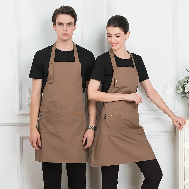 A man and a woman model an adjustable brown cotton apron in a studio setting.