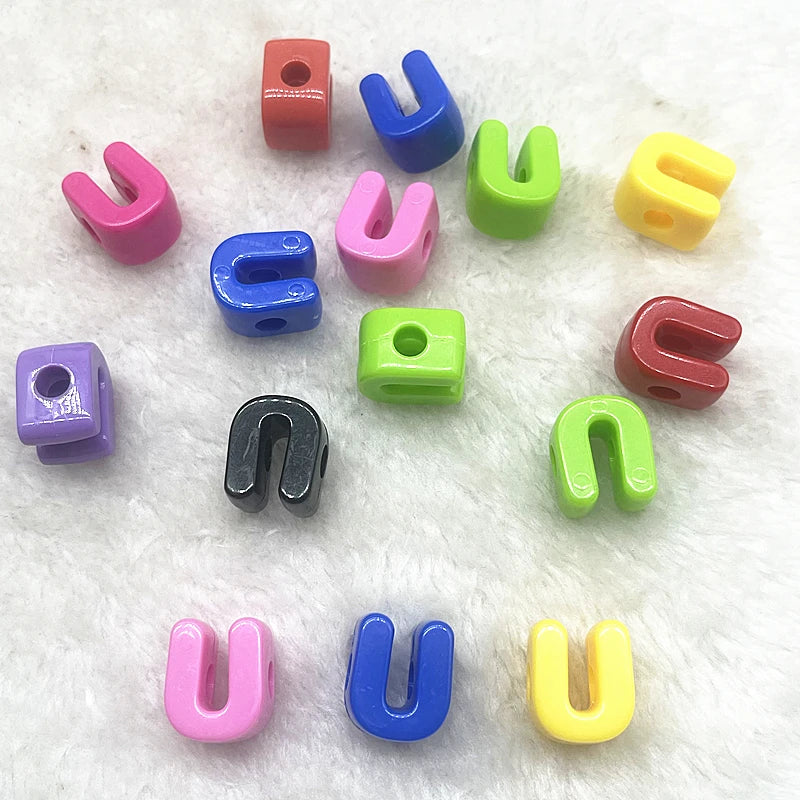 A collection of ten mixed alphabet letter beads in various colors including red, blue, pink, green, and yellow.