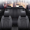 Black full coverage PU leather car seat covers installed in a vehicle interior.
