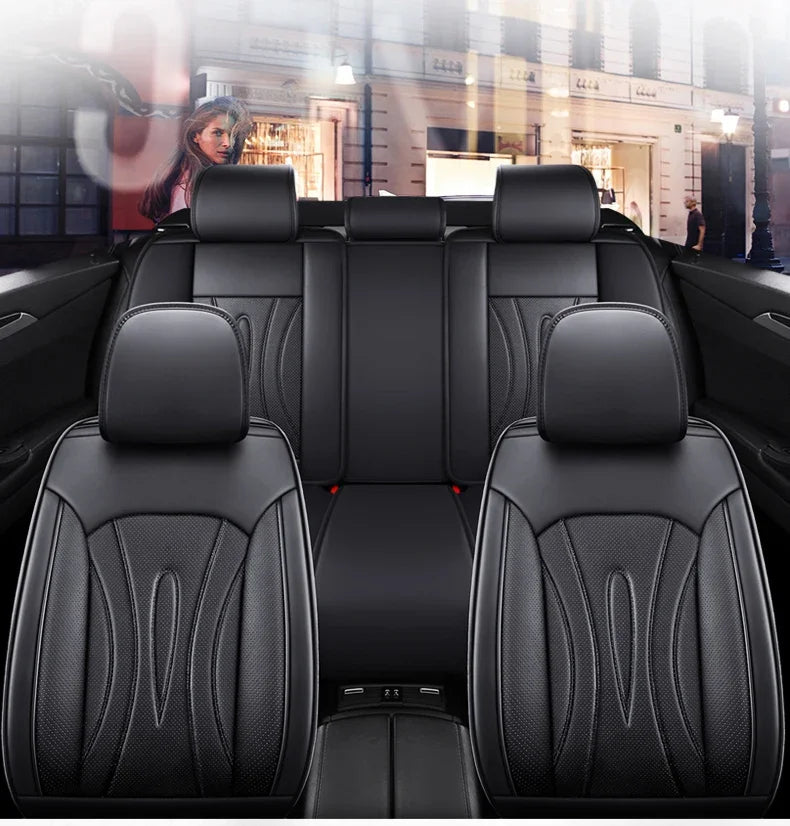 Black full coverage PU leather car seat covers installed in a vehicle interior.