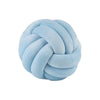 A light blue, hand-knotted velvet throw pillow with a round, textured design.