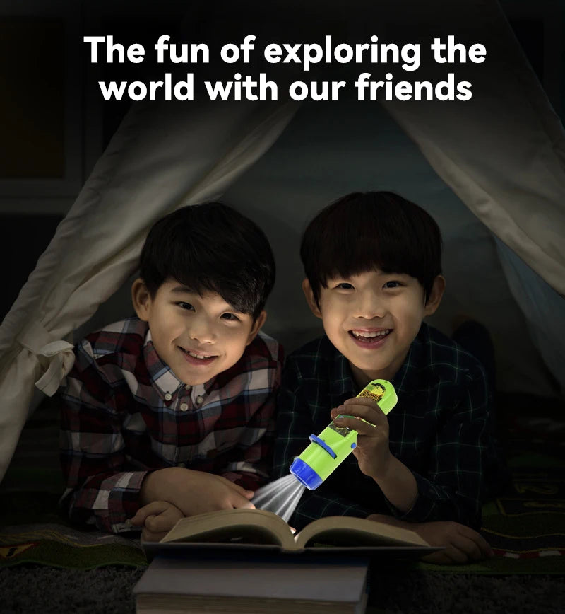 Two young boys smiling while exploring a story with an educational projector flashlight.