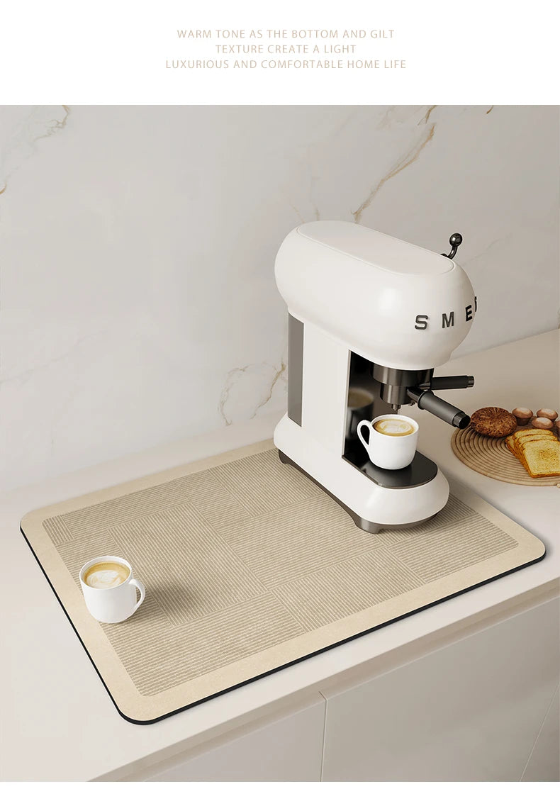 A white Smeez coffee maker sits on a beige counter mat with a white cup of coffee.