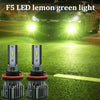 Two F5 LED lemon green headlight bulbs with cooling fans displayed on a green surface.