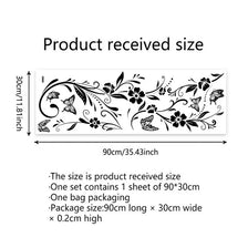 A sheet of black flower and butterfly wall stickers is shown next to a measuring tape indicating the product size.