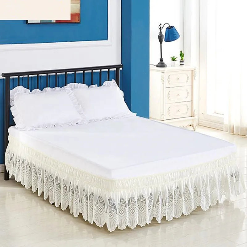 White bed skirt with lace trim and elastic band on a white bed frame