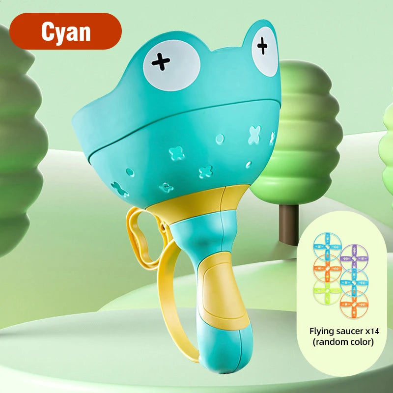 A cyan pull-string flying saucer toy for kids with a yellow base and green background.
