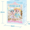 A box of The Key Collection featuring two small articulated BJD collectible figurines with light blue and pink hair and outfi