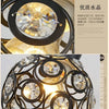 A close-up of a crystal single-head ceiling lamp with a black metal frame, showcasing the clear crystal design.