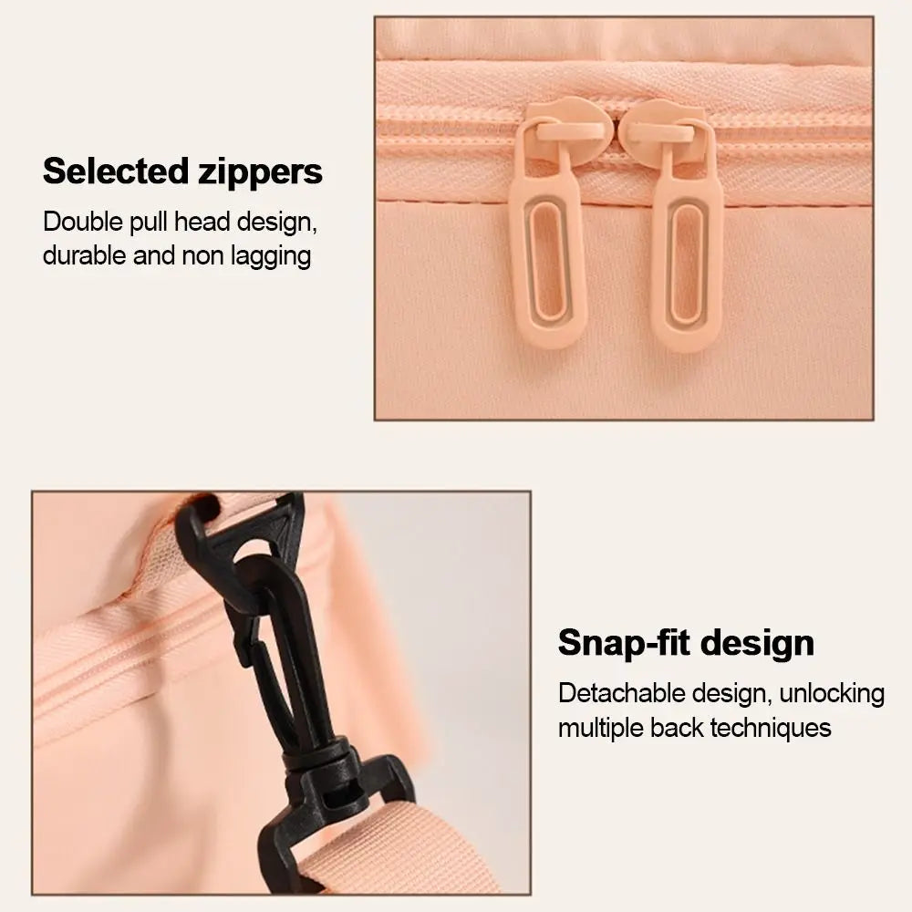 Close-up view of a pink insulated lunch bag featuring selected zippers and a snap-fit design detail.
