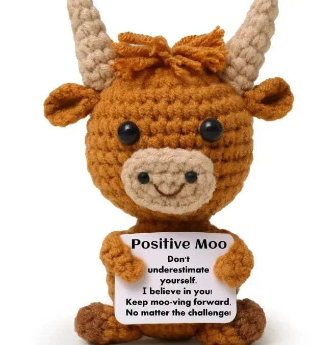A handmade crochet pocket hug doll resembling a brown calf with horns and a smiling face.