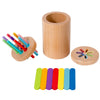 A wooden cylinder and several colored dowels used for a sorting or fine motor skills game.
