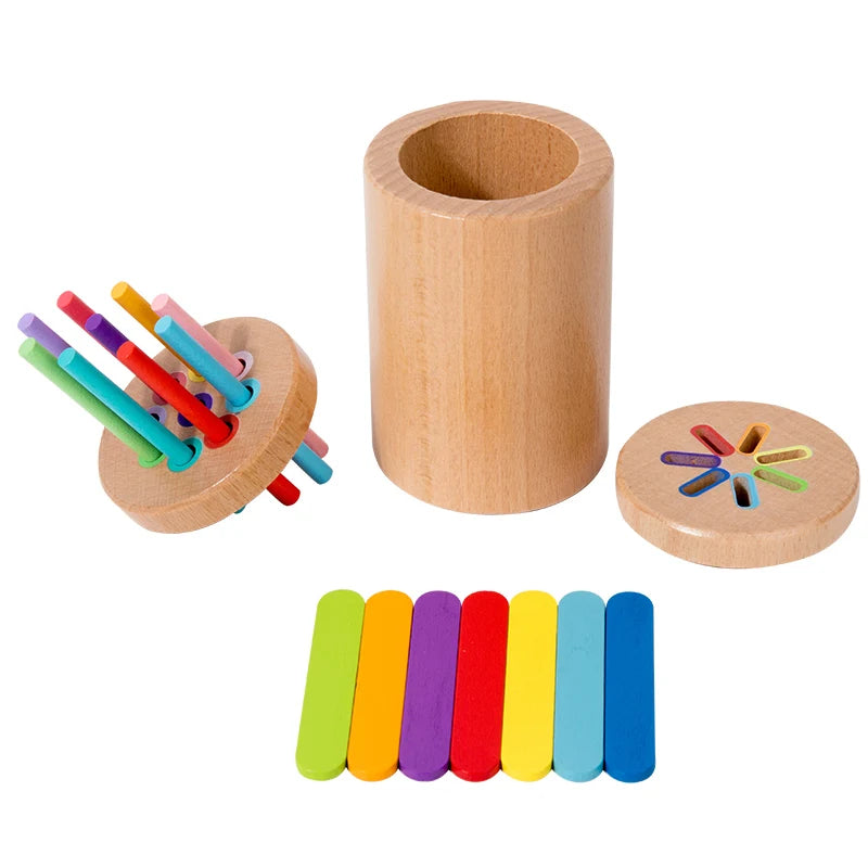 A wooden cylinder and several colored dowels used for a sorting or fine motor skills game.