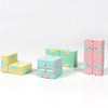 A set of colorful, translucent cubes in pastel pink, mint green, and pale yellow for a fidget toy.