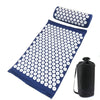A dark blue acupressure mat and pillow set with white dots for pain relief and relaxation.