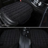 Black quilted car seat covers protecting the front seats of a vehicle.