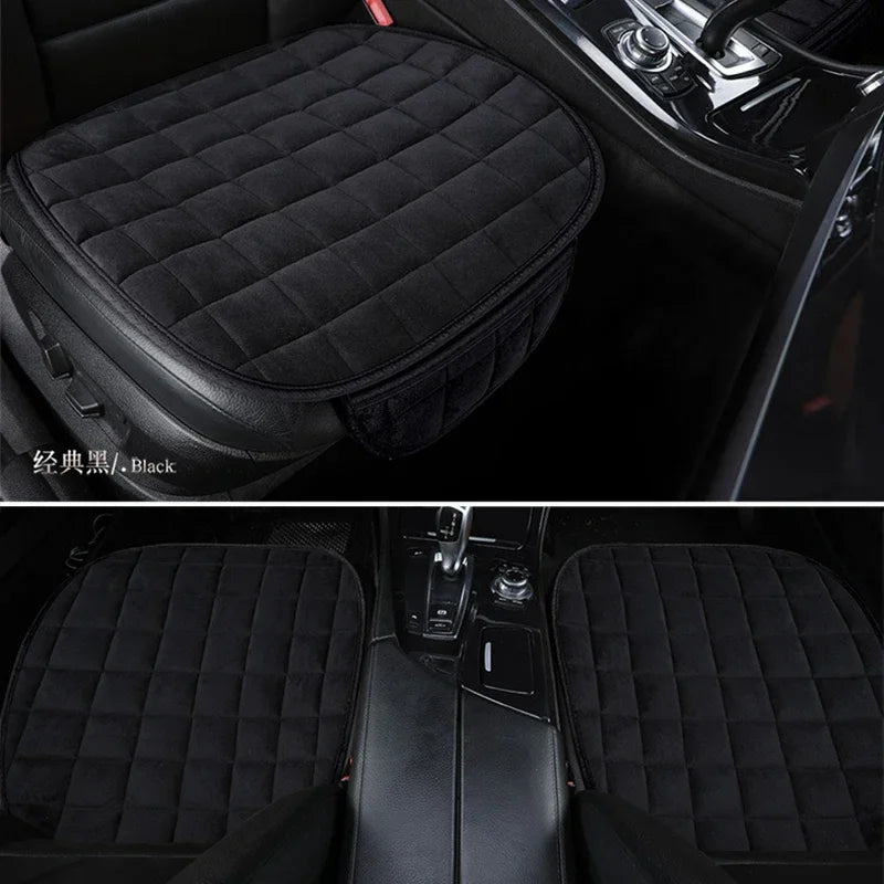 Black quilted car seat covers protecting the front seats of a vehicle.