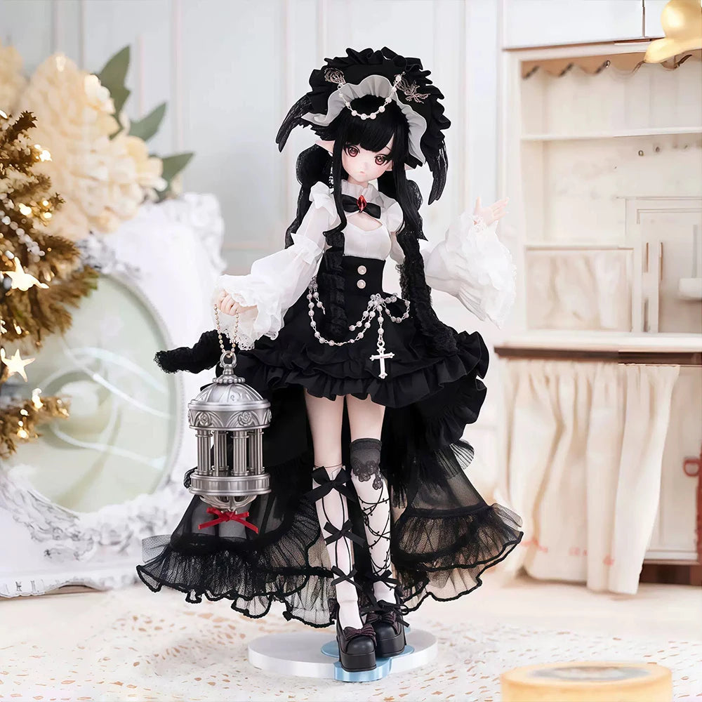 A black and white doll with dark hair wearing a gothic dress and accessories displayed on a surface.
