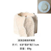 A light beige silicone mold with wavy edges used for making candle holders or plaster decor.