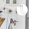 A set of four over-the-door hooks with soft rubber coating hanging on a kitchen cabinet door.