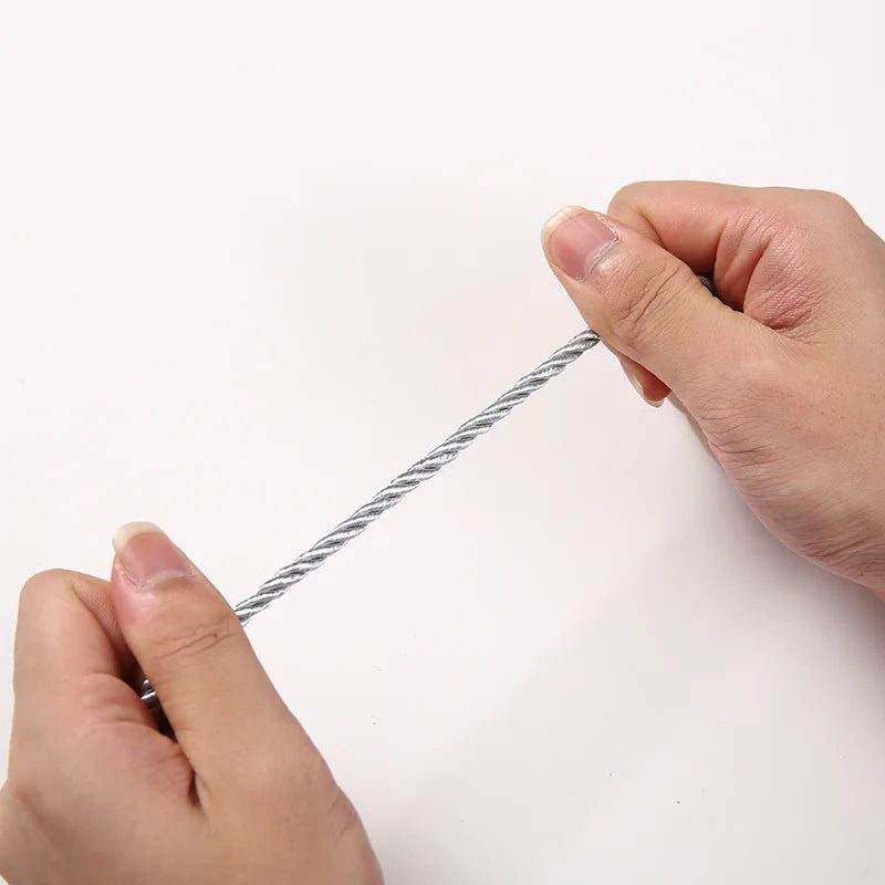 Eine Hand hält ein dünnes, graues Polyester-geflechtetes Schnur für Bastel oder Dekoration.