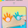 A hand is placing orange and blue wooden fingers onto a light wood surface for a Montessori counting activity.